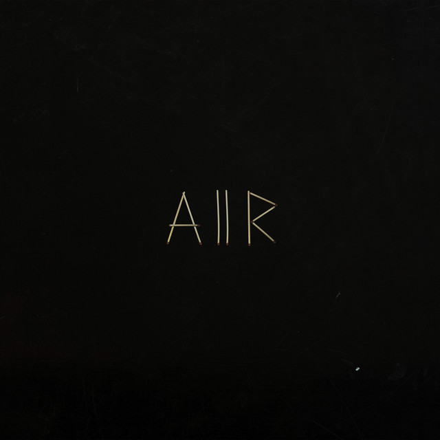 Album cover for Aiir by SAULT, featuring black dominant palette and typographic composition.